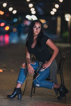 a woman sitting in a chair with her legs crossed