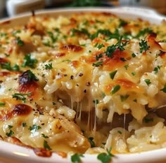 a casserole dish with chicken, cheese and parsley sprinkled on top