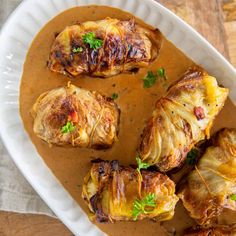 a white plate topped with potatoes covered in gravy