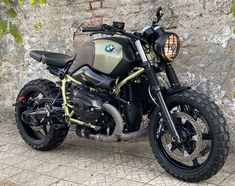 a motorcycle parked next to a stone wall