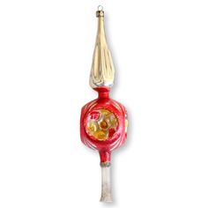 a glass ornament with a red and yellow design on it's side