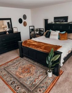 a bed room with a neatly made bed and a rug