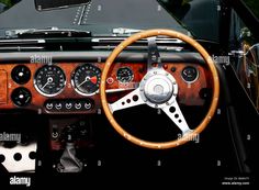 the dashboard and steering wheel of an old car