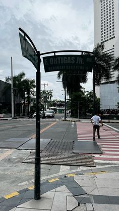 a man standing on the side of a road under a street sign that says burbasa