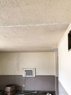 an air conditioner sitting in the middle of a room that is being remodeled with paint