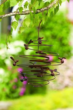 a wind chime hanging from a tree branch