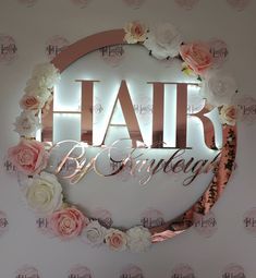 there is a sign that says hair by sunday with flowers around it and the words