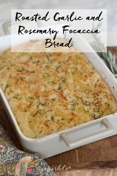 baked garlic and rosemary focaccia bread in a white casserole dish