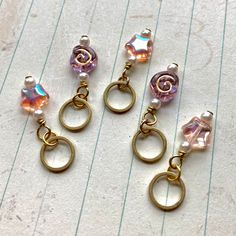 three pairs of gold tone earrings with glass beads