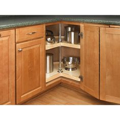 an open cabinet in the corner of a kitchen