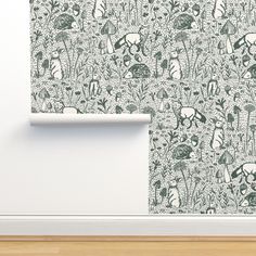 the wall paper is green and white with animals on it