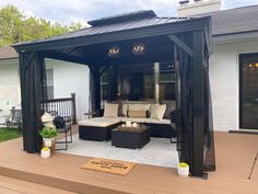 an outdoor living area with couches and tables