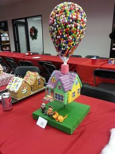 the table is set up with candy and house shaped houses on top of each other