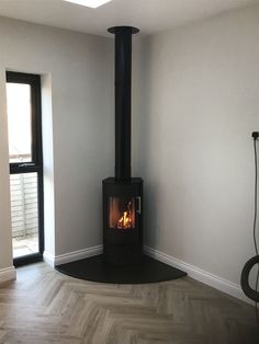 an empty room with a wood burning stove