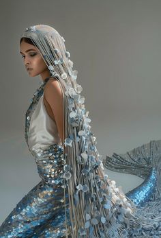 a woman is dressed in blue and silver