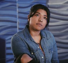 a woman with her arms crossed looking up