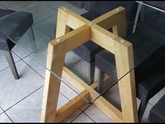 a glass table with two chairs and one chair on the floor in front of it