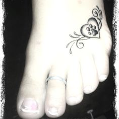 a foot with a skull and crossbone tattoo on it