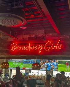 the sign above the bar says broadway girls