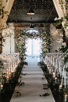 the aisle is lined with candles and flowers