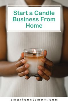 a woman holding a candle in her hands with the words start a candle business from home