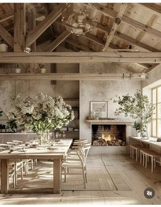 a dining room with a table and chairs in front of a fire place that is built into the wall