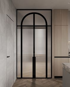 an open door leading to a bathroom with wooden floors and walls, along with a marble countertop