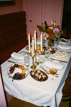 a table with plates and candles on it