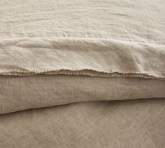 the linens are folded neatly on top of each other in this close up photo