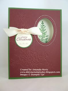 a red and green christmas card with a white bow