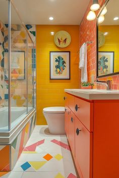 a bathroom with an orange and yellow theme