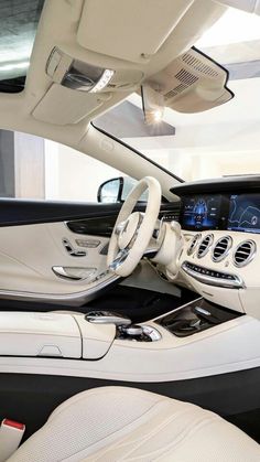 the interior of a mercedes s - class sedan with white leather seats and steering wheel