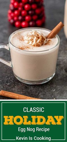 an egg nog recipe in a glass mug with cinnamon on top and holiday decorations around it