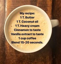 a cup of coffee on top of a wooden table with the words, my recipe 1t coconut oil 1 t heavy cream cinnamon to taste vanilla extract to taste 1