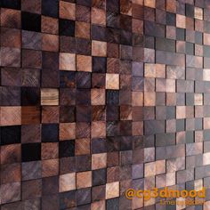 a wall made out of wooden blocks with different colors and shapes on the sides, including brown