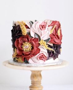 a multicolored cake with flowers on top