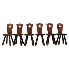 four wooden chairs sitting next to each other