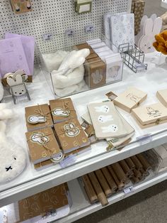 stuffed animals and other items on display in a store or showroom, including boxes with bunny ears