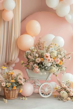 a baby carriage with flowers and balloons in the background