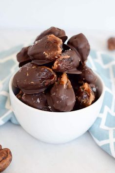 a bowl filled with chocolate covered pretzels on top of a blue and white towel