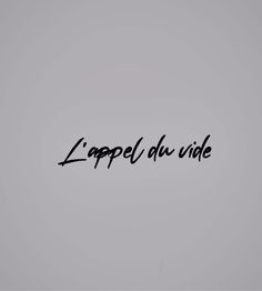 the word l'appel du vide written in black ink on a gray background