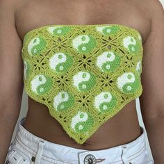 a woman wearing a green crocheted crop top