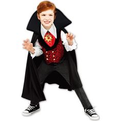 a young boy dressed up in a dracula costume and holding his hands out to the side