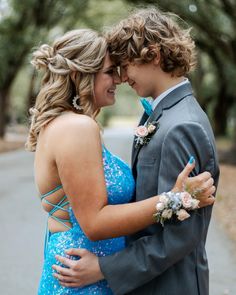 a young man and woman embracing each other