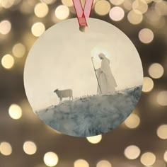 a christmas ornament with a shepherd and sheep