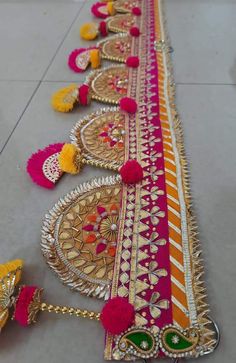 a long row of colorful tassels sitting on top of a floor