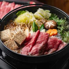 a close up of a bowl of food with meat and veggies on it