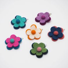 A lovely flower hair clip, hand made from merino wool, that brings a pop of colour to any hairstyle. A quirky and cute way to style your hair, our flower hair clip keep your hair secure whilst also looking great.  All of our felt products are made by one of the leading Fair Trade felt makers in Nepal. Instead of weaving the wool, felt is created by applying heat, moisture and pressure to the wool to entangle the fibres and create a beautiful end result. The felt is coloured using only natural dy Personalised Photo Albums, Felt Hair Bows, Felt Products, Photo Album Journal, School Hair, Leather Photo Albums, Card Holder Purse, Felt Garland, Flower Hair Clip