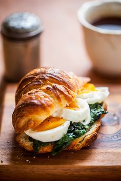 a sandwich with an egg and spinach on it