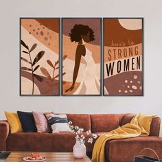 two posters on the wall above a couch in a living room with a coffee table